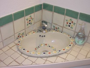 Bathroom’s small but charming with hand-painted sink & Mexican tiles.