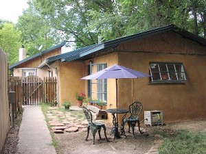 Sit under the cottonwoods and enjoy the backyard.