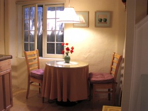 Dine by the window on chairs with comfy cushions.